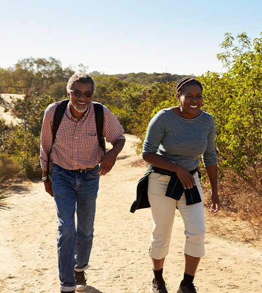 two adults hiking on a sunny day